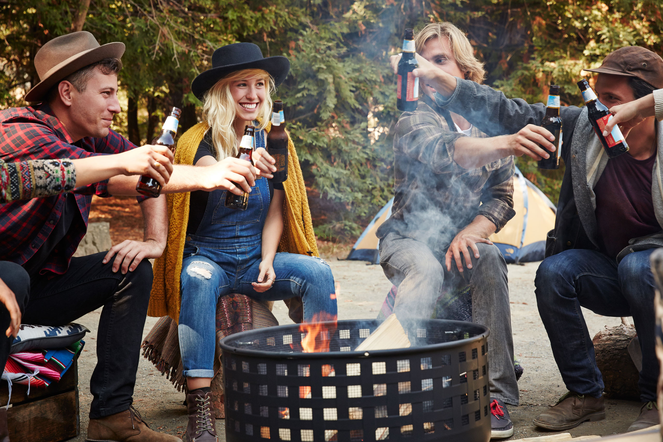 Four guests cheer by the fire