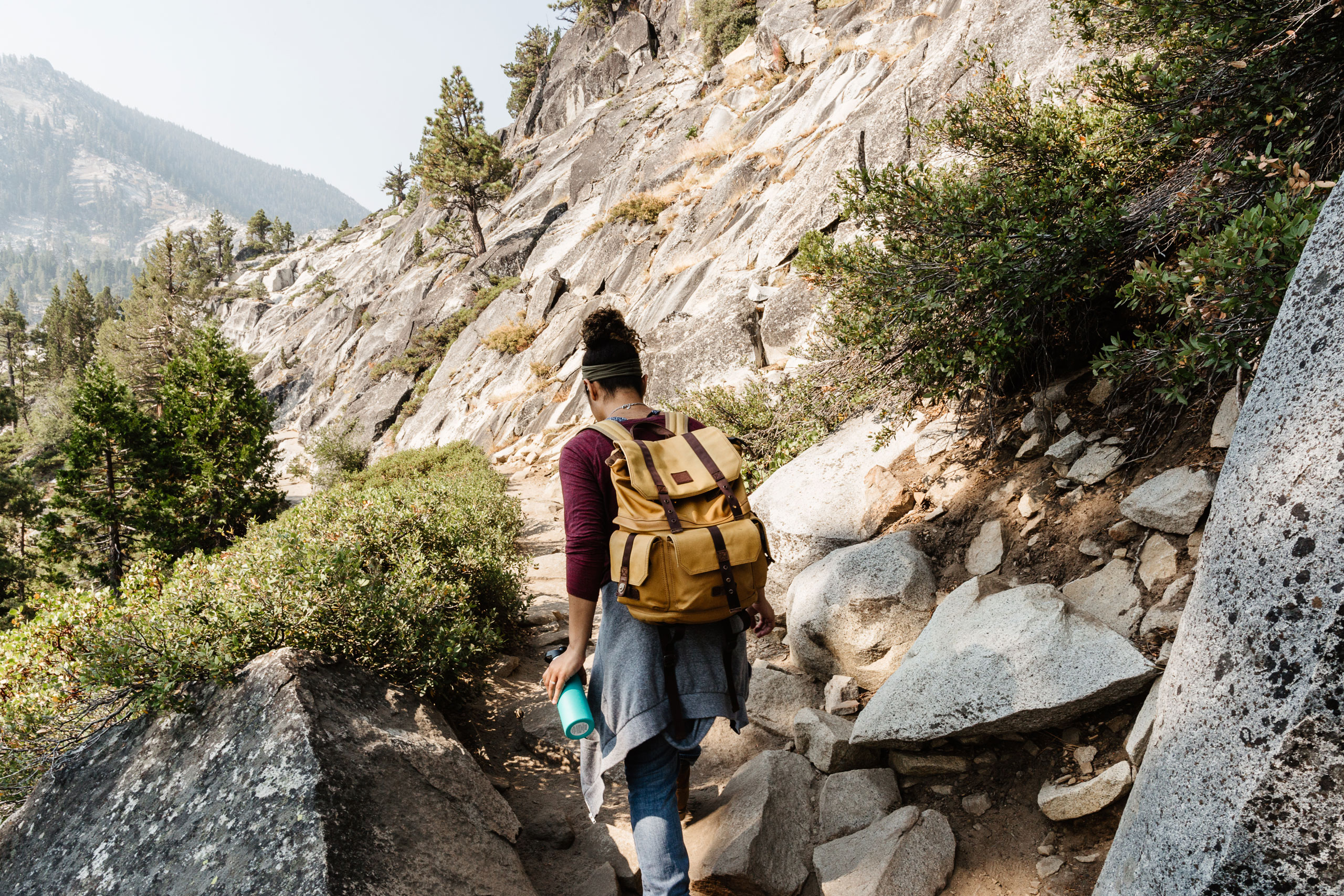 Hiker yellow backpack trail